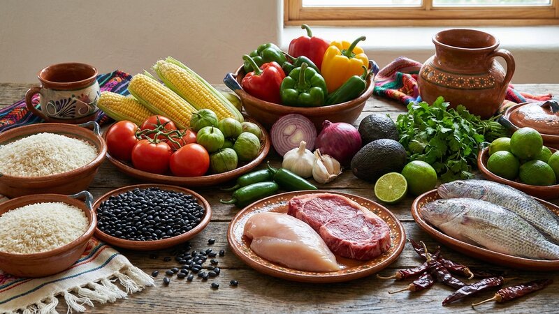 Fresh Mexican food ingredients including rice, beans, vegetables and proteins