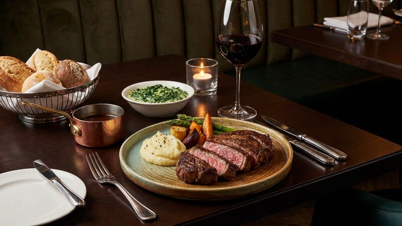 Restaurant steak dinner with vegetables and side dishes