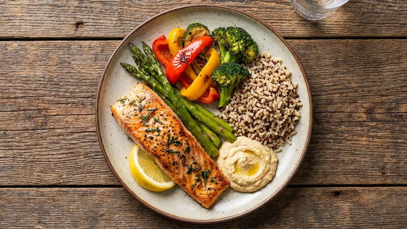 Healthy balanced meal plate with grilled protein, vegetables, and whole grains